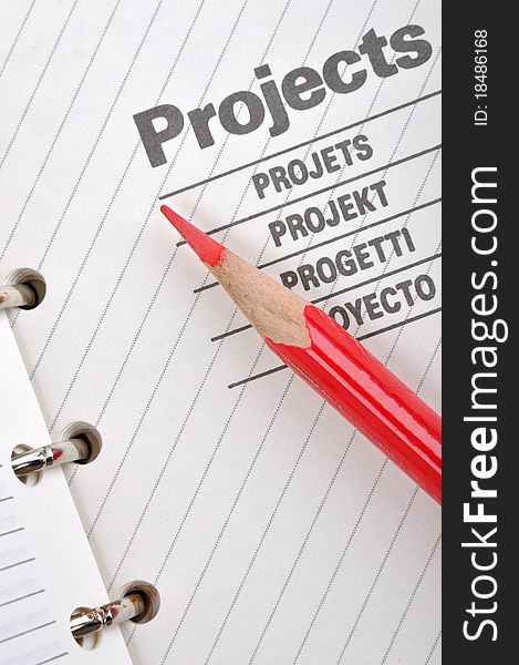 Project book page with a red pencil, shown as project woking and other business concept. Project book page with a red pencil, shown as project woking and other business concept.