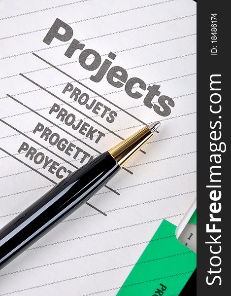 Project book page and a ball pen, shown as project woking and other business concept. Project book page and a ball pen, shown as project woking and other business concept.