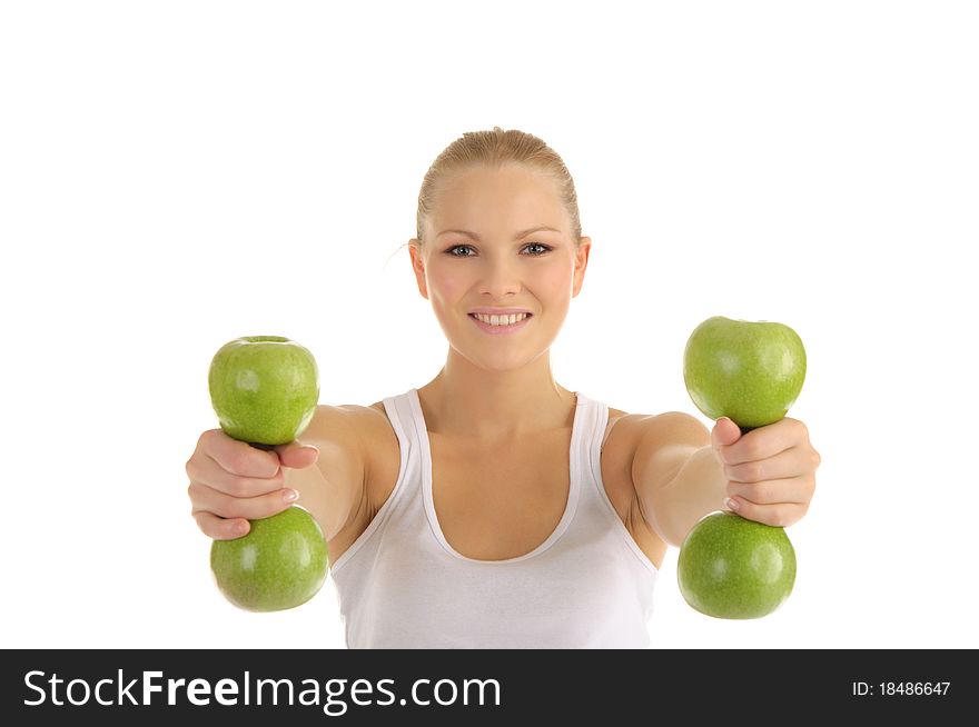 Woman engaged in fitness dumbbells from apples isolated on white