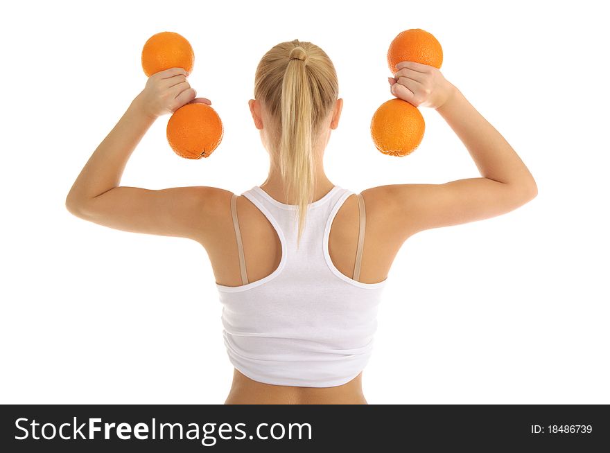 Woman engaged in fitness dumbbells of oranges isolated on white