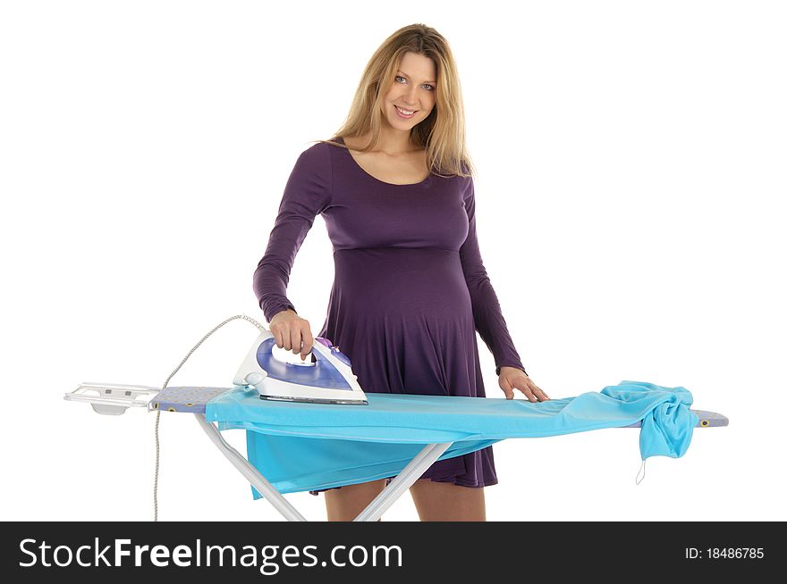 Pregnant woman in a purple dress with an iron isolated on white