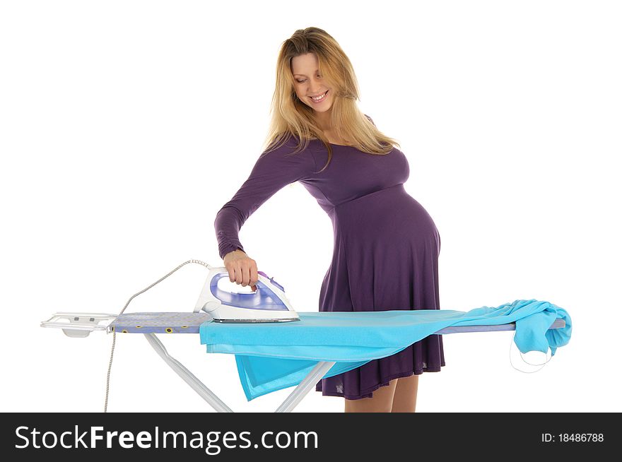 Pregnant woman in a purple dress with an iron isolated on white