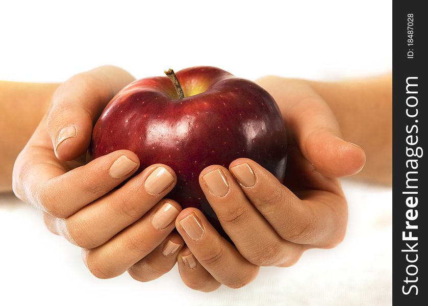 Fresh red apple in a woman hand close up