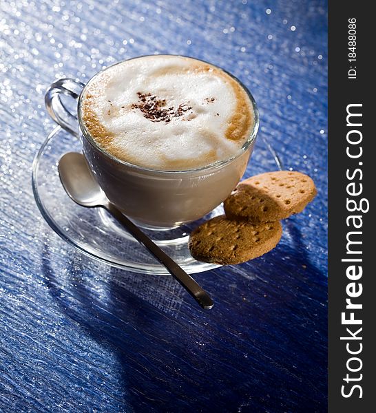 Cappuccino on blue glass table