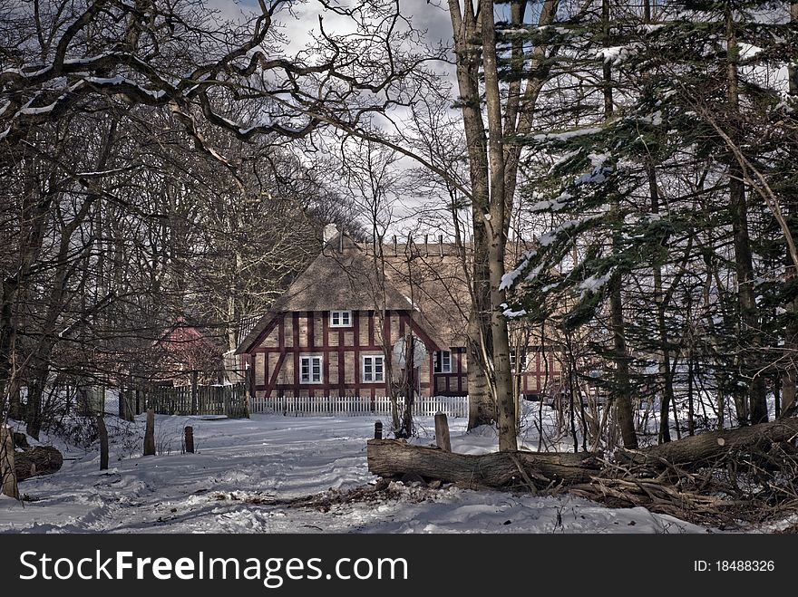 Half-timbered house with thatched roof in a forest in Denmark. Half-timbered house with thatched roof in a forest in Denmark