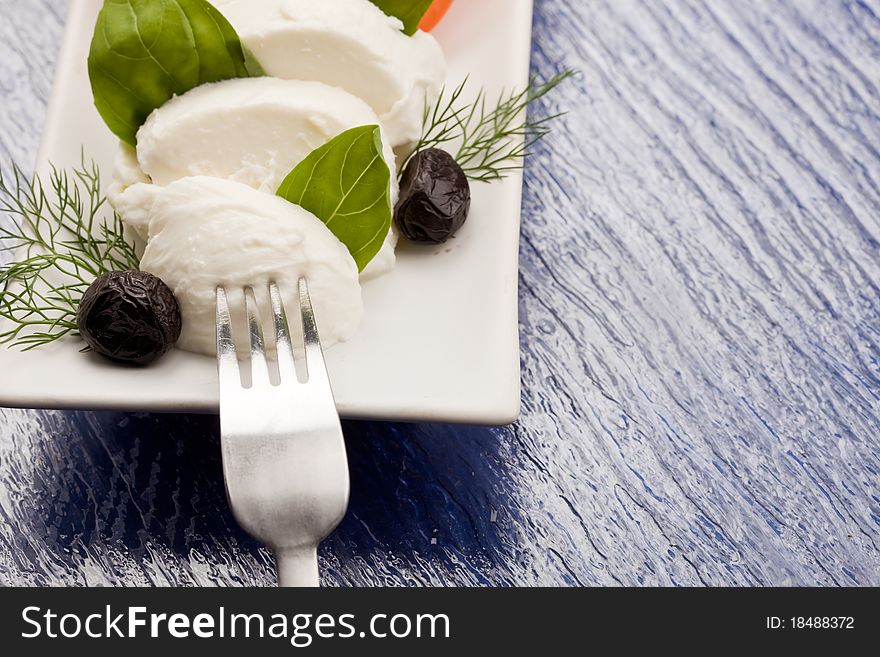 Photo of delicious tomatoe and mozzarella salad with black olives. Photo of delicious tomatoe and mozzarella salad with black olives