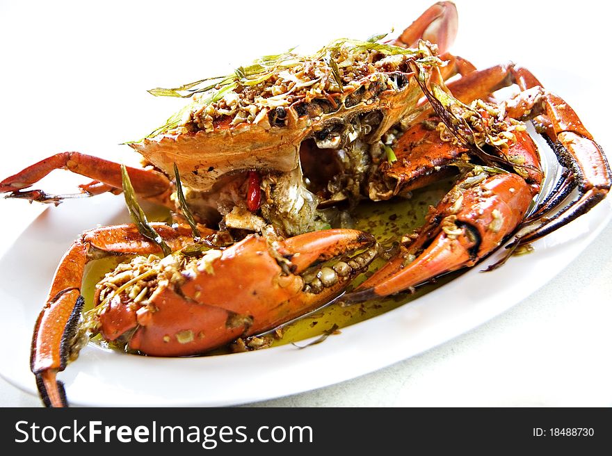 An Chinese fried crab on white dish