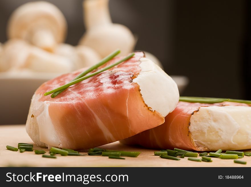Photo of delicious fresh white cheese with a slice of bacon wrapped arround. Photo of delicious fresh white cheese with a slice of bacon wrapped arround