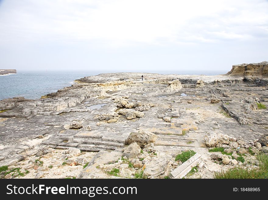 Far Woman On Rock Coastline