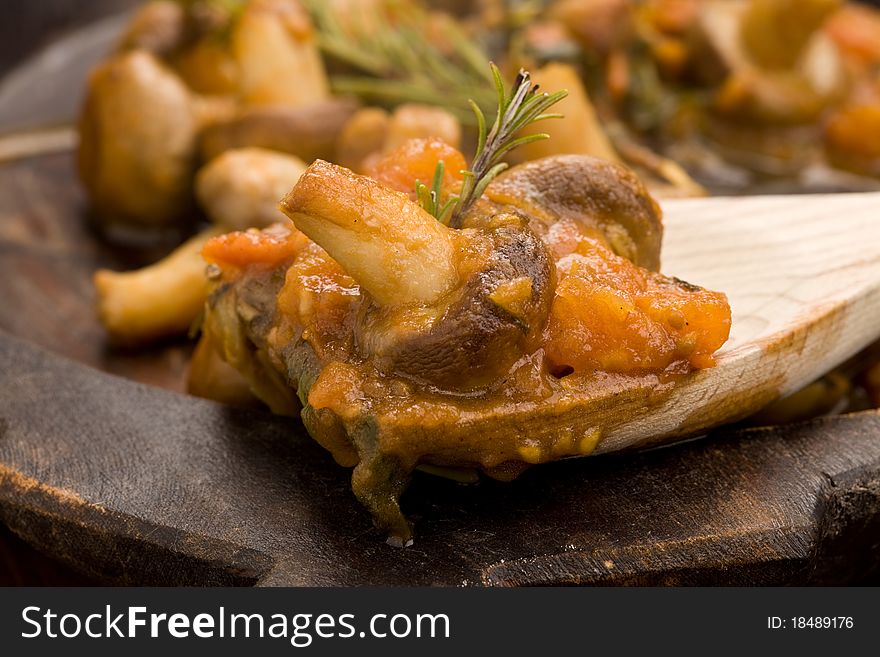 Photo of cooked mushrooms with fresh tomatoe and rosemary. Photo of cooked mushrooms with fresh tomatoe and rosemary