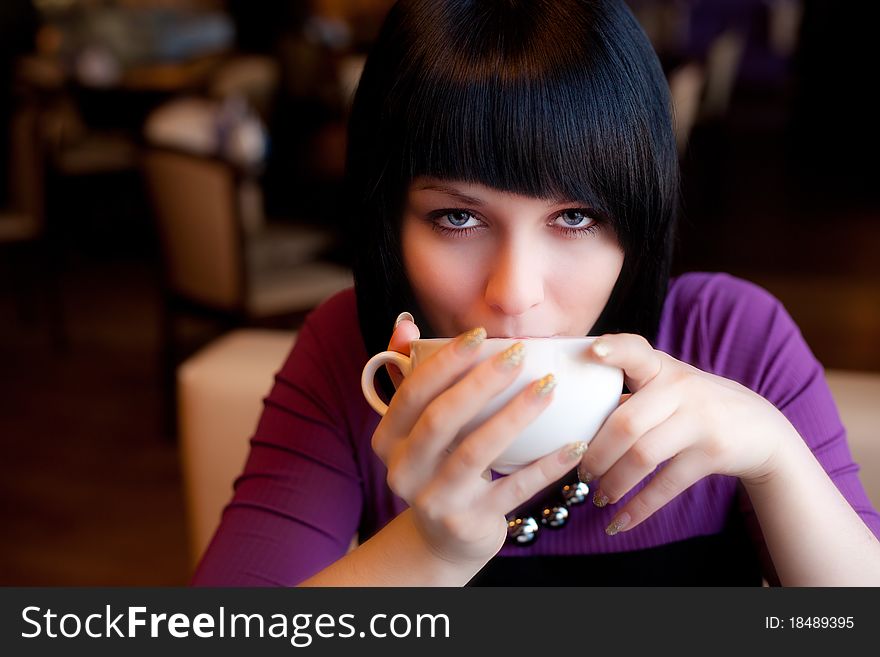 Girl hold cup of coffee in hand look straight. Girl hold cup of coffee in hand look straight