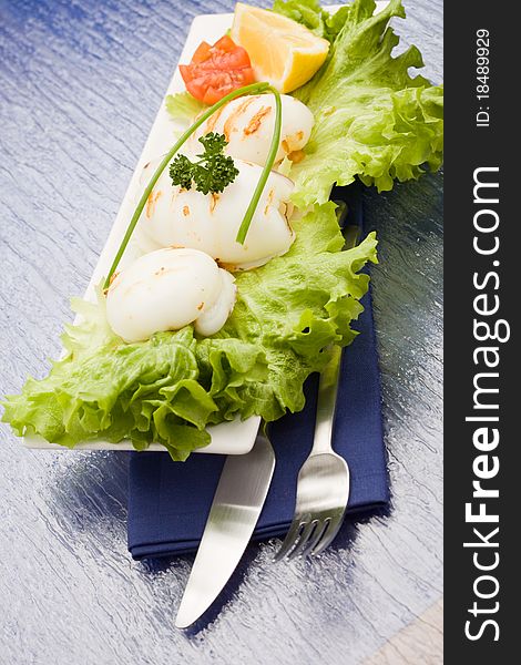 Squid With Lettuce On Blue Glasstable