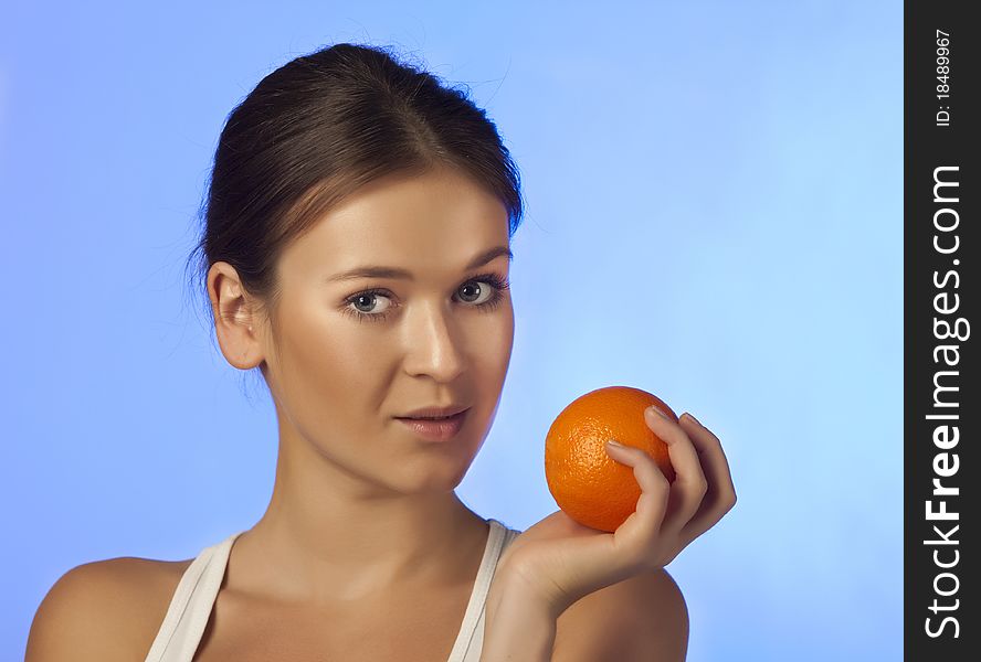 The woman with an orange fruit isolated