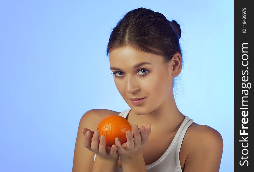 The woman with an orange fruit isolated