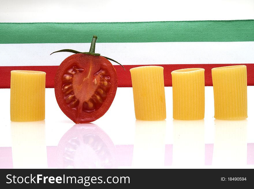 Italian flag with pasta and half tomatoe on white background. Italian flag with pasta and half tomatoe on white background