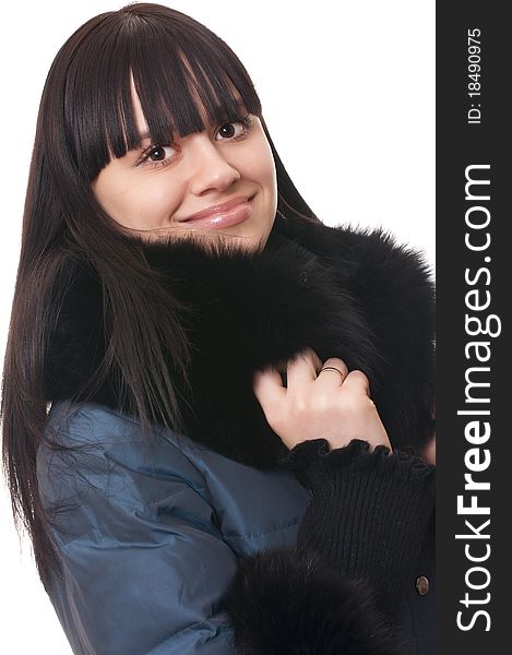 Young beautiful girl in winter jacket with fur