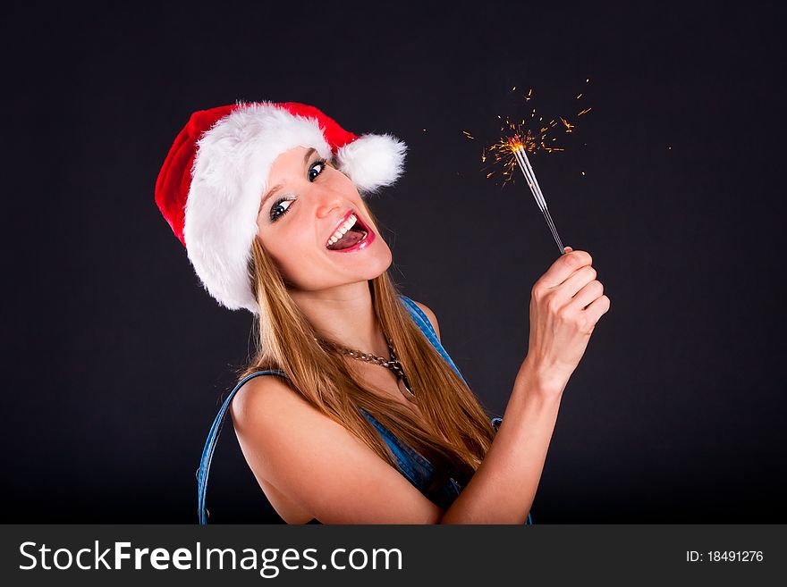 Cute girl in Santa hat holding sparklers. Cute girl in Santa hat holding sparklers