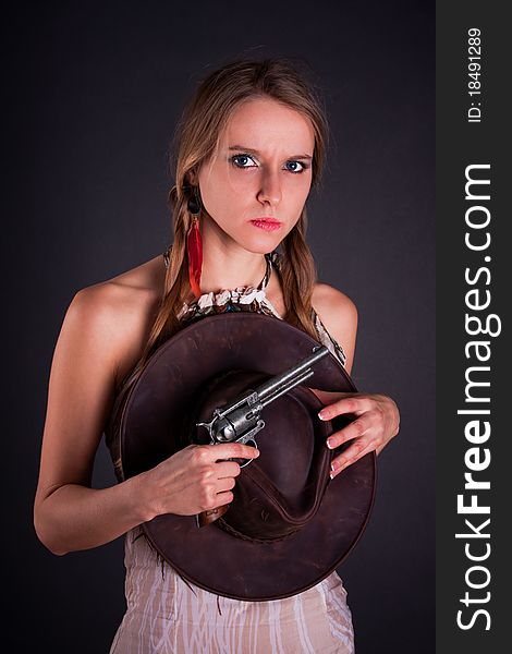 The American Indian girl with a cowboy's hat holds a pistol