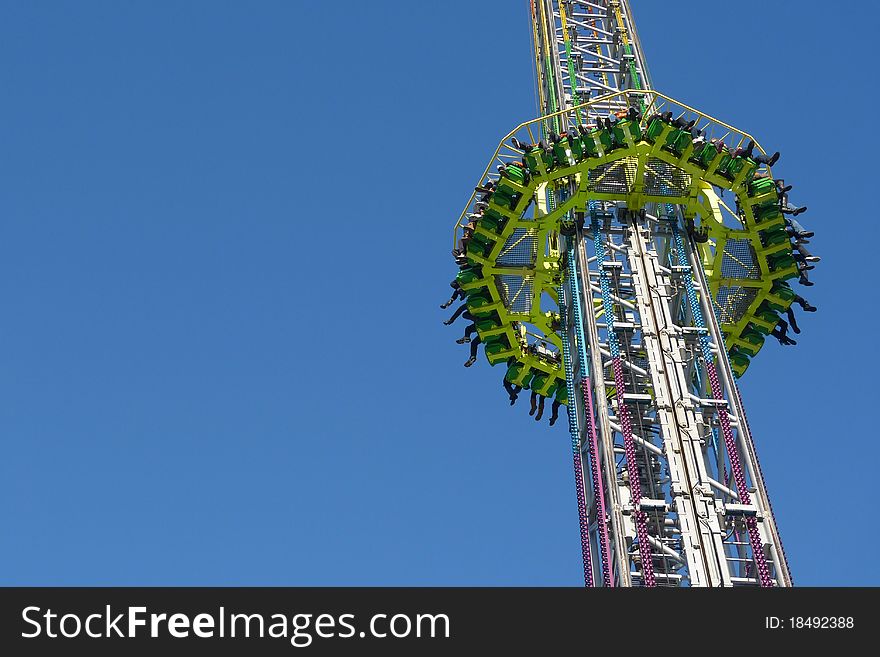 Amusement-park ride against brilliant blue sky; excellent copy-space. Amusement-park ride against brilliant blue sky; excellent copy-space