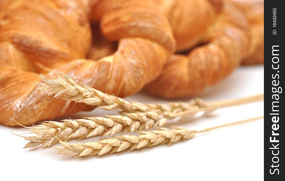 Bread with wheat ears on white background