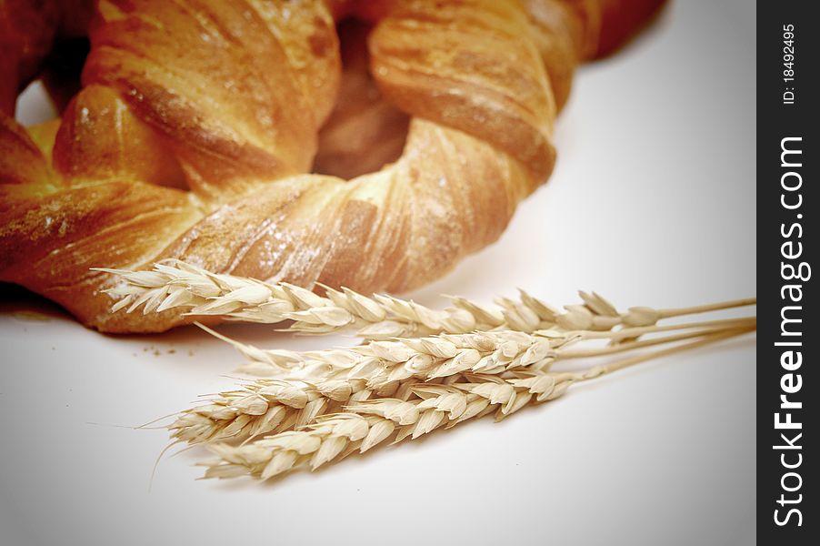 Bread with wheat ears on white background