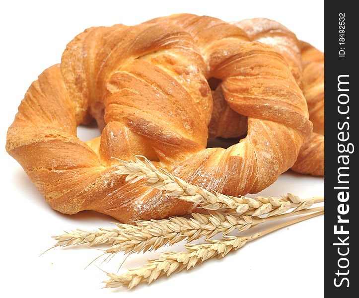 Bread with wheat ears on white background