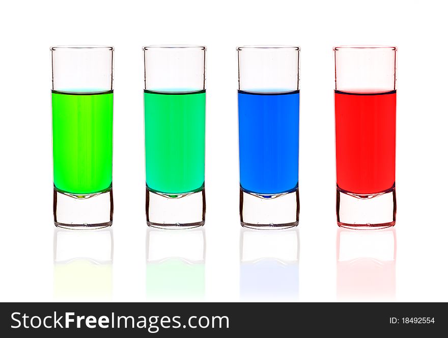 Four shot-glasses of brightly-colored cocktails - isolated on white ground. Four shot-glasses of brightly-colored cocktails - isolated on white ground