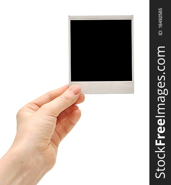 One instant photo in hand isolated on white background. One instant photo in hand isolated on white background