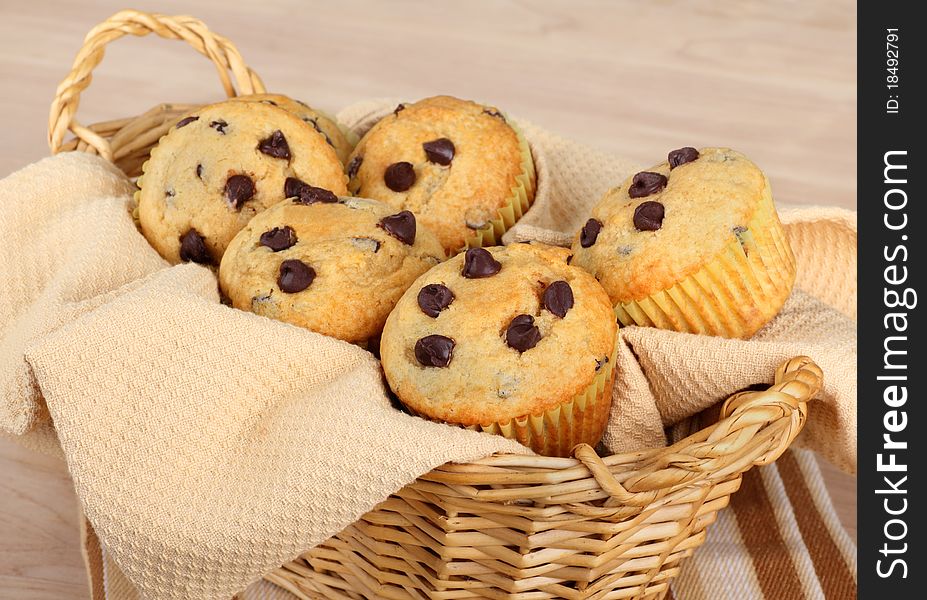 Baked chocolate chip muffins in a basket