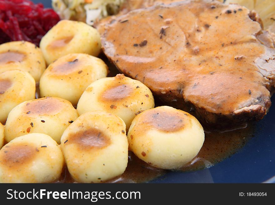 Pork steak and dumplings with side salads