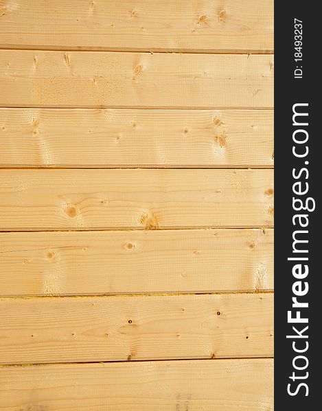 A fragment of a wall of the wooden house on a background photo. A fragment of a wall of the wooden house on a background photo