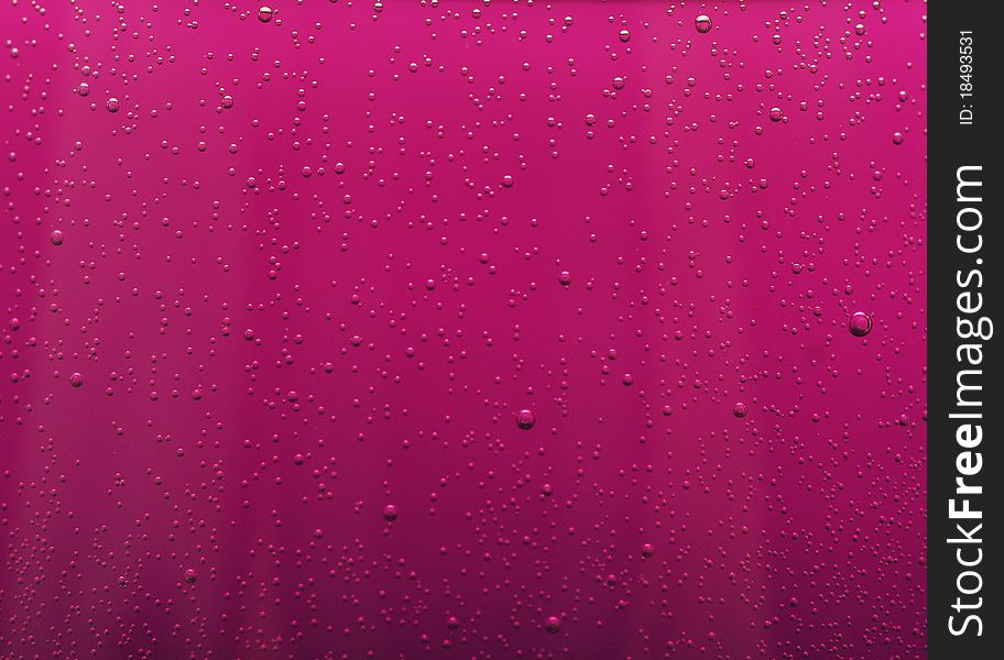 Water drops on abstract red surface