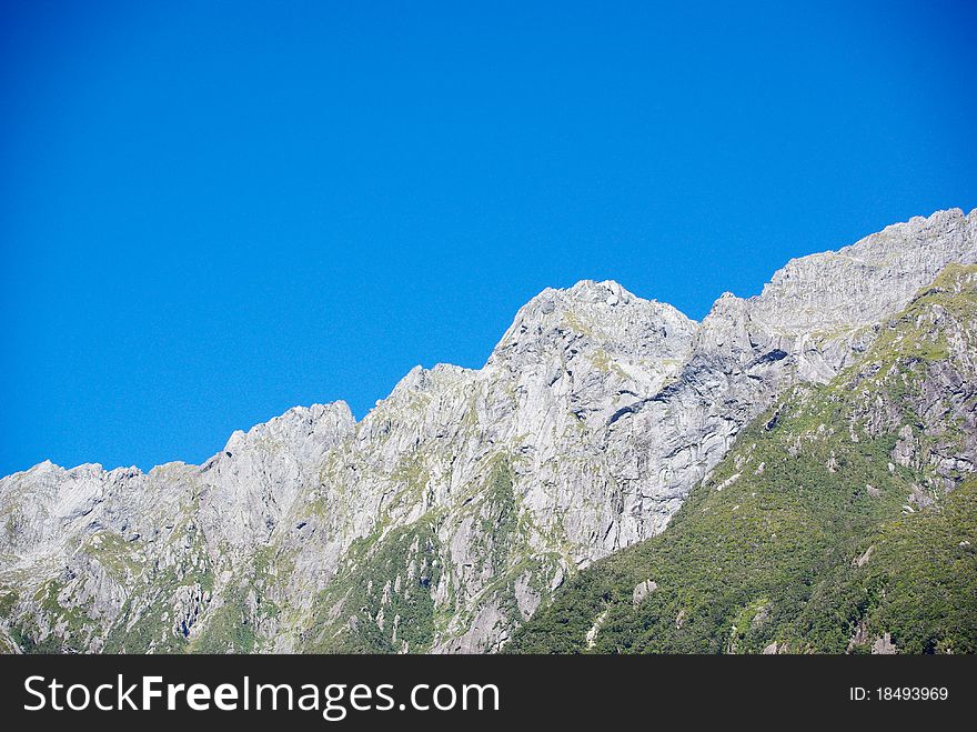 A Milford Sound landscape contrasting between pure sky and pure rock. A Milford Sound landscape contrasting between pure sky and pure rock