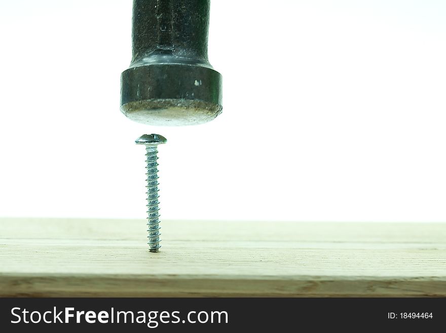 Close-up Claw Hammer Trying to Hit Screw into Wood