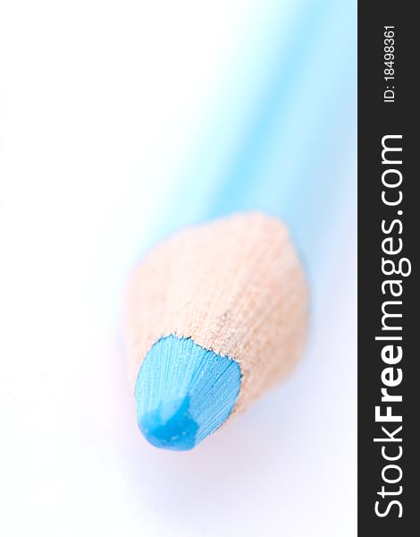 Closeup of a blue crayon isolated on a white backgrund. Has a shallow depth of field.