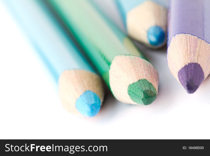 Four colorful crayons on white background with a shallow depth of field for effect. Four colorful crayons on white background with a shallow depth of field for effect.