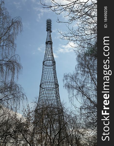 Shukhov radio and TV tower in Moscow, Russia among the trees. The Tower was built in 1922. Shukhov radio and TV tower in Moscow, Russia among the trees. The Tower was built in 1922.