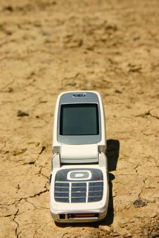 White Mobile Phone In A Dry River Bed Royalty Free Stock Images