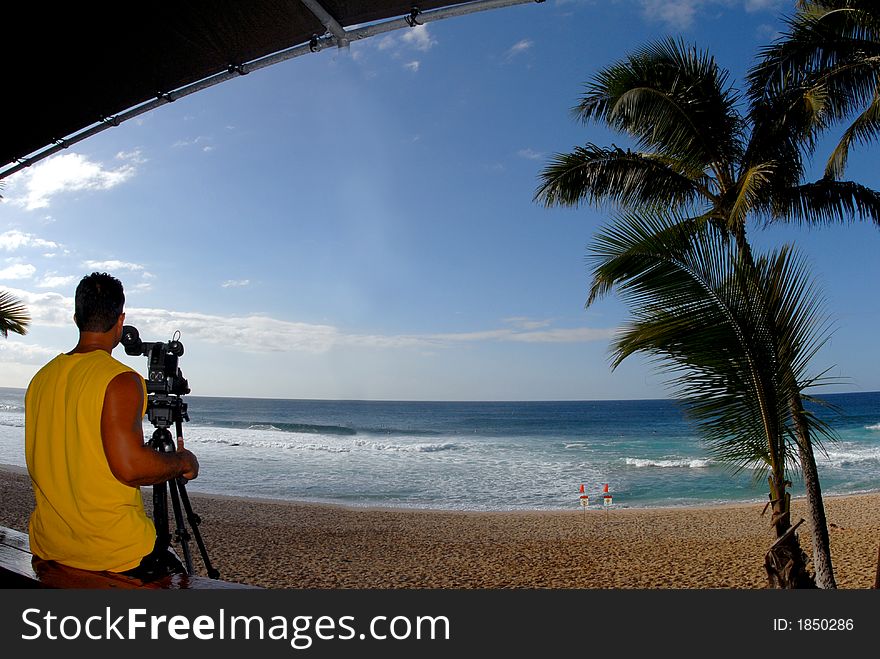 A man filming some actions at North Shore of Oahu. A man filming some actions at North Shore of Oahu