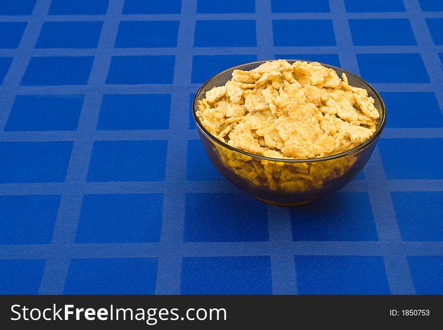 Bowl of muesli on blue tablecloth