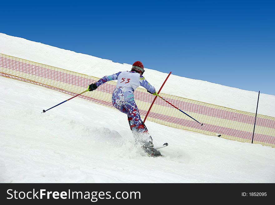 Young skier doing downhill slalom. Young skier doing downhill slalom