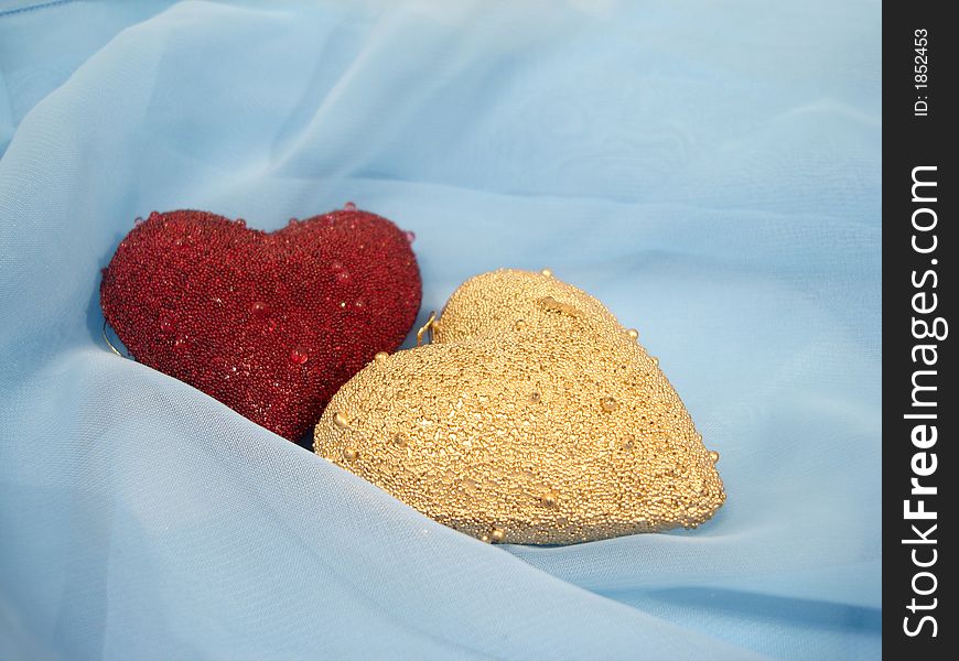 Red And Golden Hearts On A Blue Background