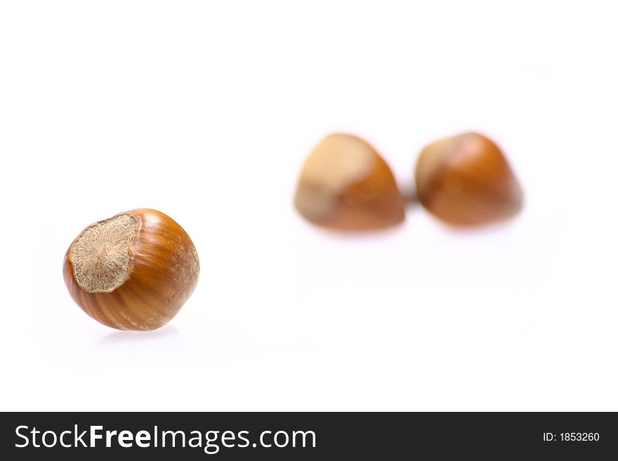 Closeup for little hazelnuts isolated on white background
