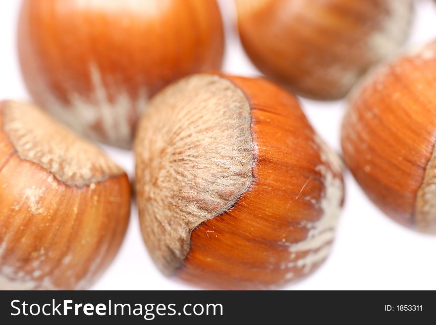 Closeup for little hazelnuts isolated on white background