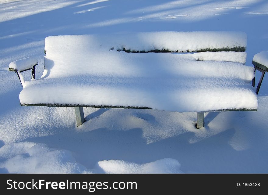 Park-bench covered with snow