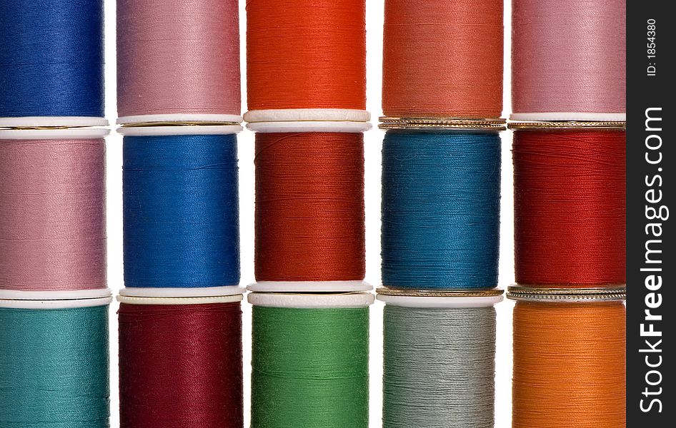 Different spools of thread create a colorful background. Different spools of thread create a colorful background