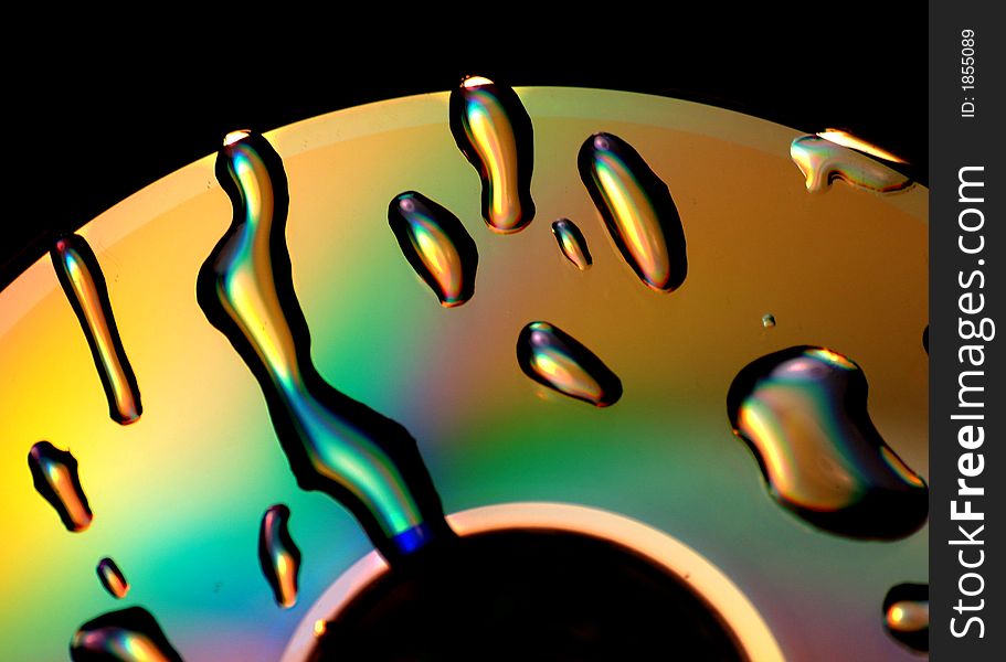 A photo of water droplets on a dvd. A photo of water droplets on a dvd