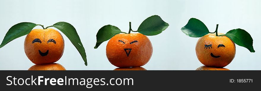 Oranges with leaves show us some faces. Oranges with leaves show us some faces.