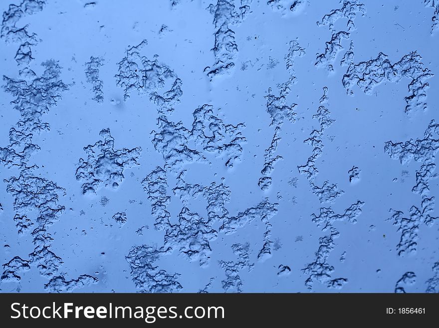 Snowflakes on a window, melting, close-up. Snowflakes on a window, melting, close-up