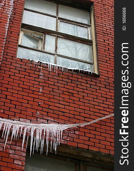 Frozen window on a red brick wall